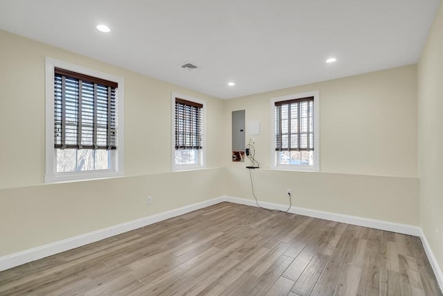 unfurnished room featuring electric panel and light wood-type flooring