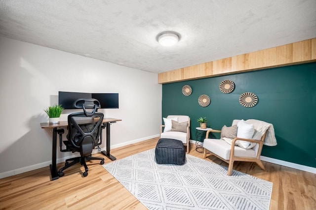 office space with baseboards and wood finished floors