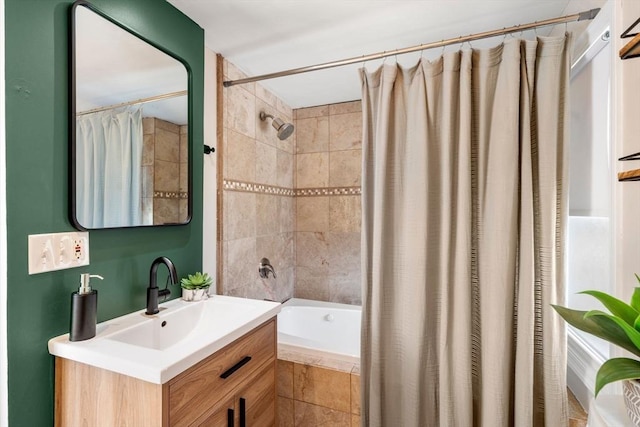 full bathroom featuring vanity and tiled shower / bath combo