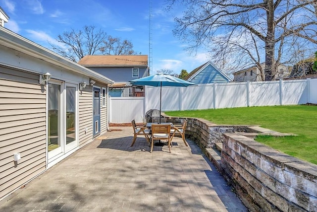 view of patio with outdoor dining area and a fenced backyard
