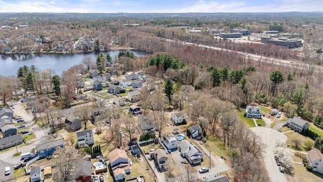 birds eye view of property with a water view, a residential view, and a wooded view