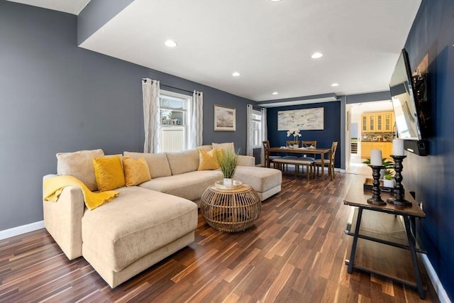 living area featuring recessed lighting, baseboards, and dark wood finished floors