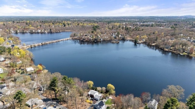 drone / aerial view featuring a water view and a forest view