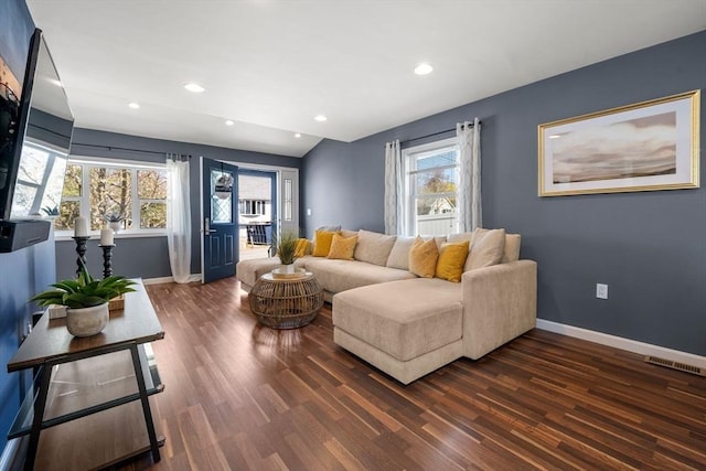 living room featuring baseboards, visible vents, a wealth of natural light, and dark wood-type flooring