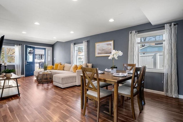 dining space featuring baseboards, plenty of natural light, and wood finished floors