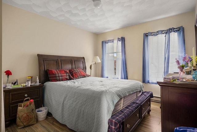 1438 Somerset Ave, Taunton, MA 02780 - bedroom with wood finished floors and a baseboard radiator