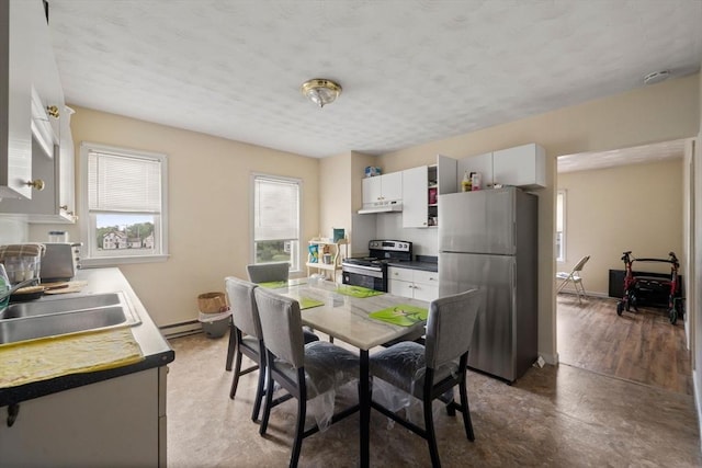 1438 Somerset Ave, Taunton, MA 02780 - dining room featuring a baseboard heating unit, baseboards, and a textured ceiling