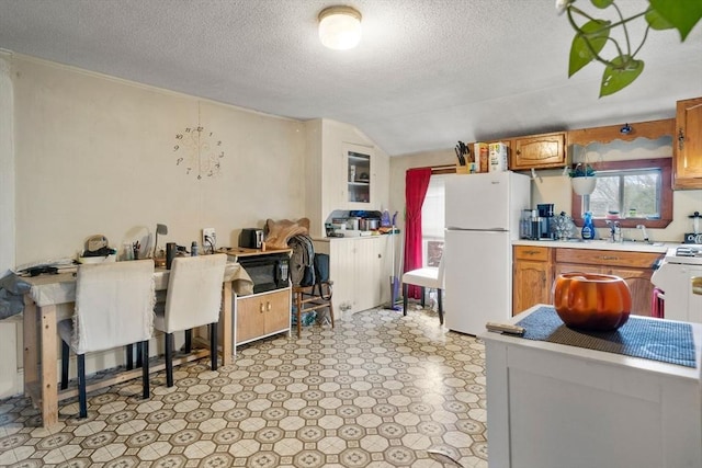 1438 Somerset Ave, Taunton, MA 02780 - kitchen with freestanding refrigerator, light countertops, black microwave, a textured ceiling, and a sink