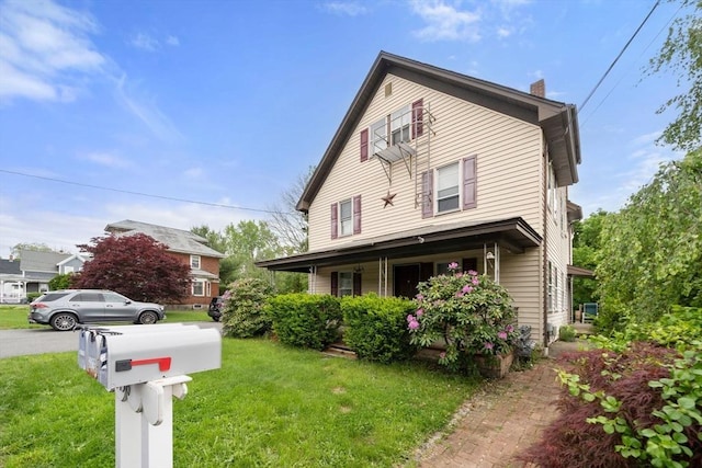 1438 Somerset Ave, Taunton, MA 02780 - view of front of house with a chimney, a front lawn, and a porch