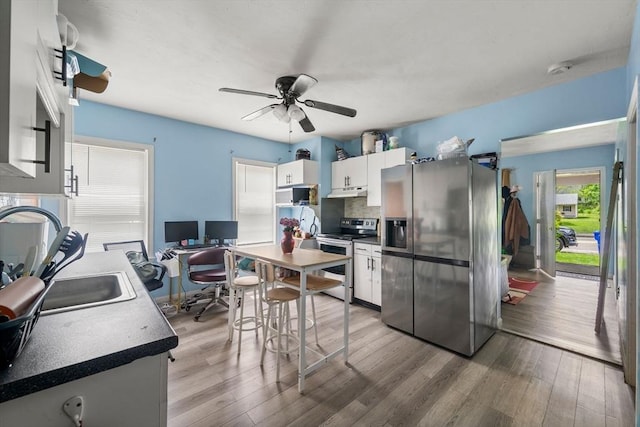 1438 Somerset Ave, Taunton, MA 02780 - kitchen featuring stainless steel appliances, an office area, white cabinets, and wood finished floors