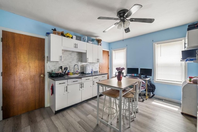 1438 Somerset Ave, Taunton, MA 02780 - kitchen with a sink, dark countertops, light wood-type flooring, and ceiling fan