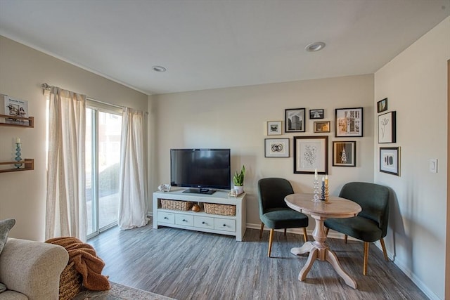 sitting room with baseboards and wood finished floors