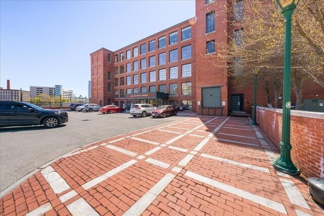 view of building exterior featuring uncovered parking