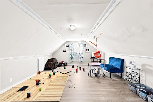 game room featuring lofted ceiling, wood finished floors, and baseboards