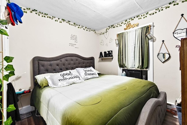 bedroom featuring dark wood-style floors and baseboards