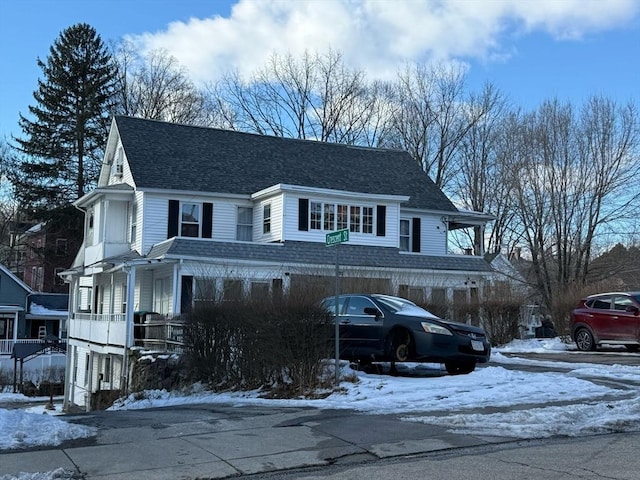 view of front of property with covered porch and roof with shingles