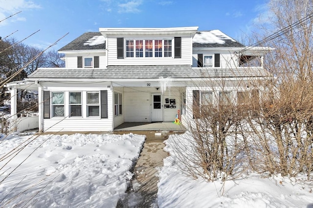 view of front of home with a shingled roof