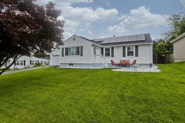 83 Chalmers St, Springfield, MA 01118 - back of property with roof mounted solar panels and a garage
