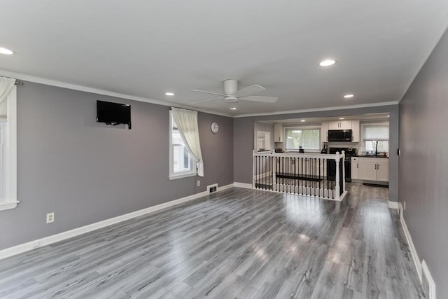 83 Chalmers St, Springfield, MA 01118 - unfurnished living room featuring ceiling fan, wood finished floors, recessed lighting, ornamental molding, and baseboards