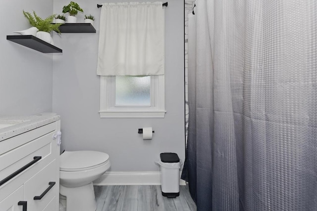 83 Chalmers St, Springfield, MA 01118 - bathroom with toilet, vanity, baseboards, wood finished floors, and a shower with shower curtain