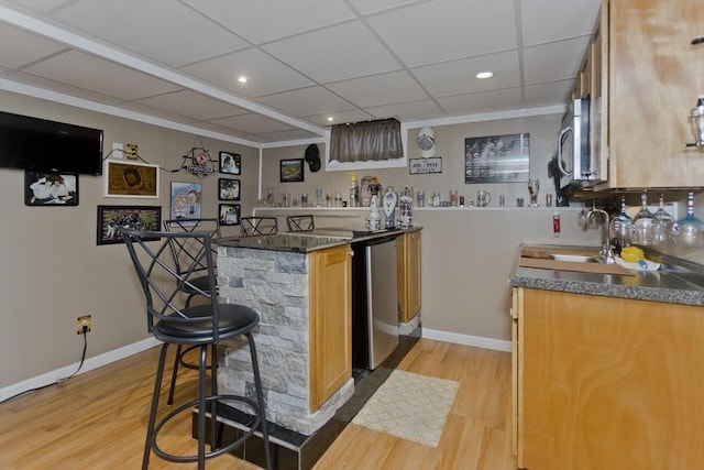 83 Chalmers St, Springfield, MA 01118 - indoor wet bar featuring light wood-style flooring, baseboards, recessed lighting, stainless steel microwave, and a drop ceiling