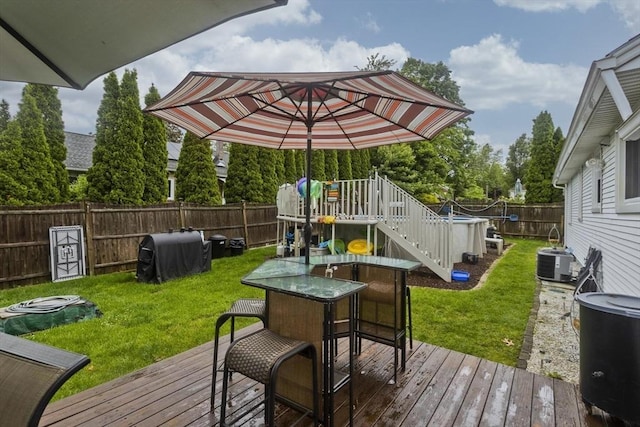 83 Chalmers St, Springfield, MA 01118 - wooden terrace with central AC unit, a grill, and outdoor dining area