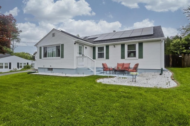 83 Chalmers St, Springfield, MA 01118 - back of property featuring roof mounted solar panels, outdoor lounge area, and a patio area