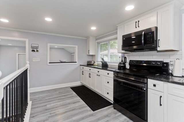 83 Chalmers St, Springfield, MA 01118 - kitchen with black electric range oven, white cabinets, backsplash, light wood finished floors, and recessed lighting