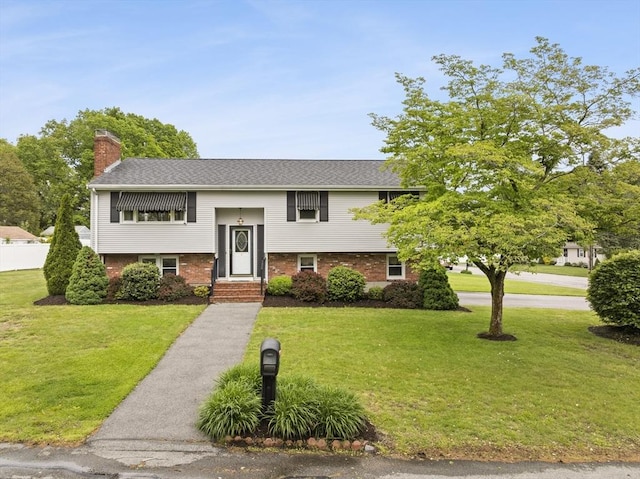 171 Duffy Dr, Taunton, MA 02780 - raised ranch with a chimney, a front lawn, and brick siding