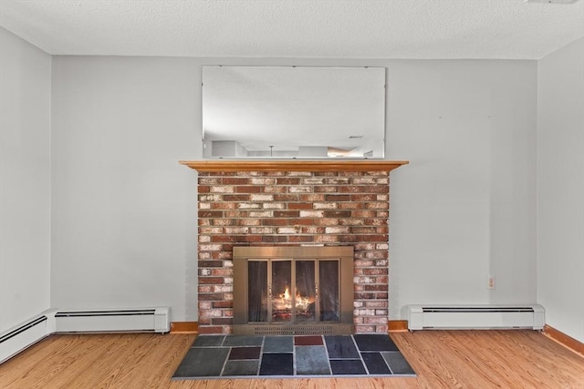 171 Duffy Dr, Taunton, MA 02780 - detailed view of a baseboard heating unit, a fireplace, wood finished floors, baseboards, and a textured ceiling