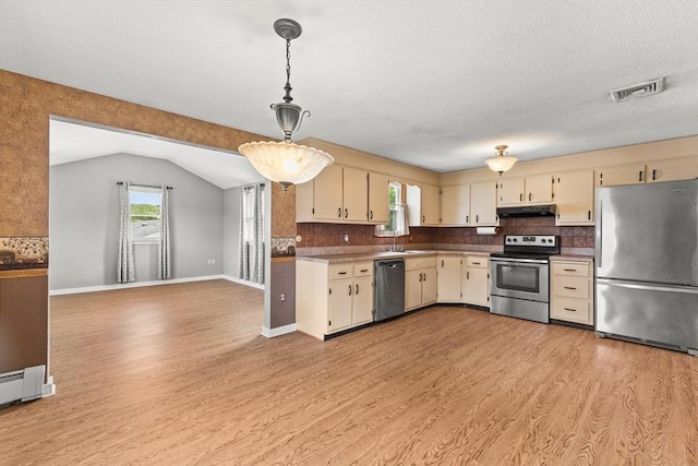 171 Duffy Dr, Taunton, MA 02780 - kitchen featuring stainless steel appliances, under cabinet range hood, cream cabinetry, light wood-type flooring, and lofted ceiling