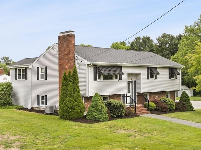171 Duffy Dr, Taunton, MA 02780 - view of front of home featuring central AC unit, a front lawn, a chimney, and brick siding