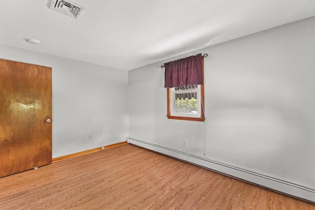 171 Duffy Dr, Taunton, MA 02780 - spare room featuring a baseboard radiator, wood finished floors, baseboards, and a textured ceiling