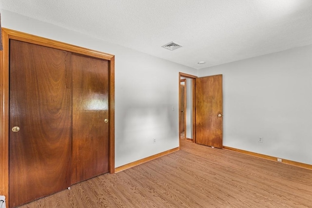 171 Duffy Dr, Taunton, MA 02780 - unfurnished bedroom featuring wood finished floors, baseboards, and a closet