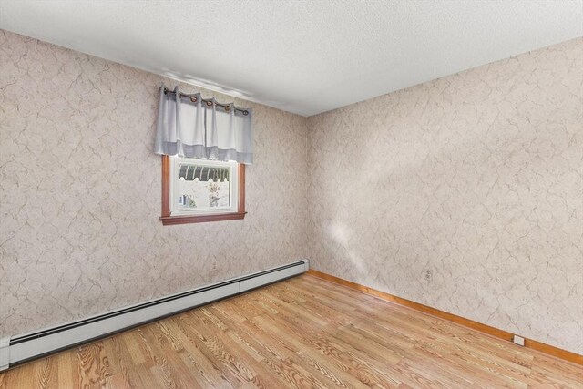 171 Duffy Dr, Taunton, MA 02780 - spare room featuring a baseboard radiator, wood finished floors, baseboards, and a textured ceiling