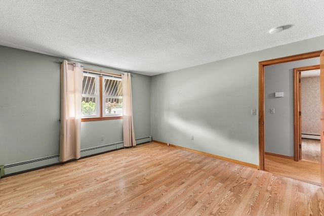 171 Duffy Dr, Taunton, MA 02780 - empty room with wood finished floors, a textured ceiling, baseboard heating, a smoke detector, and baseboards