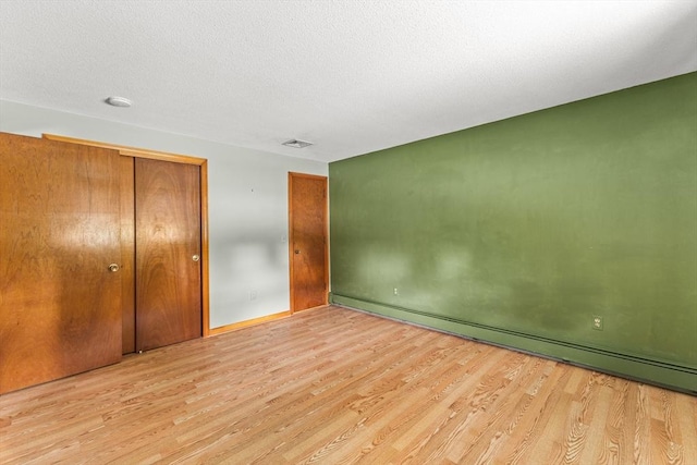171 Duffy Dr, Taunton, MA 02780 - unfurnished bedroom featuring wood finished floors, a baseboard heating unit, a closet, and baseboards