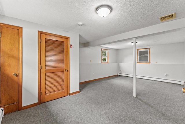 171 Duffy Dr, Taunton, MA 02780 - basement with a baseboard radiator, carpet floors, baseboards, and a textured ceiling