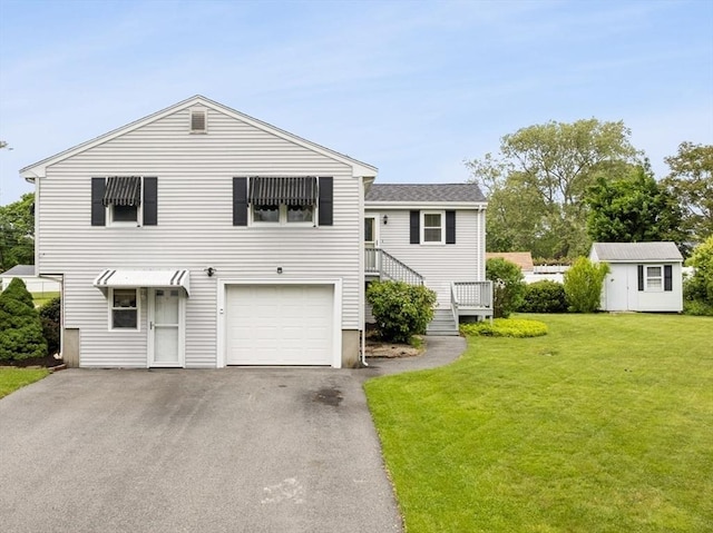 171 Duffy Dr, Taunton, MA 02780 - view of front of property with a front lawn, asphalt driveway, an attached garage, and an outdoor structure