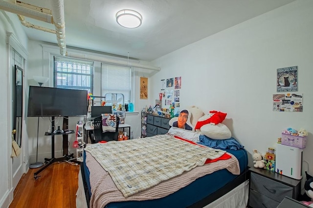 bedroom featuring wood finished floors