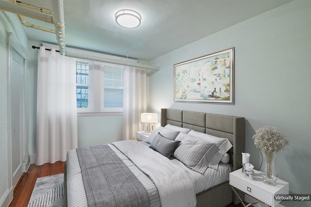 bedroom featuring wood finished floors