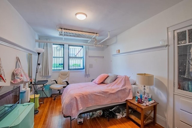 bedroom with wood-type flooring