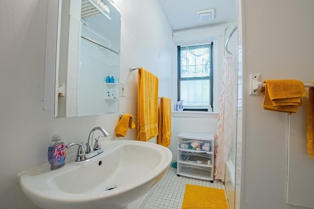 full bathroom with a sink, tile patterned flooring, and shower / bathtub combination with curtain