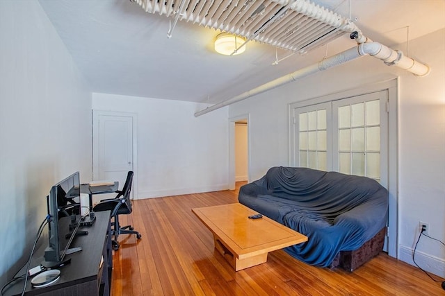 living area with hardwood / wood-style floors and baseboards