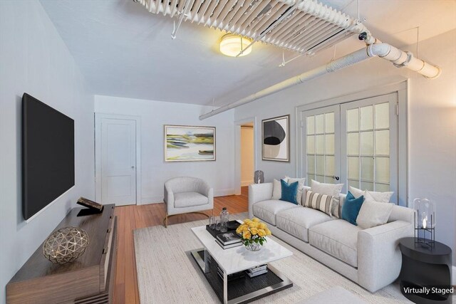living area with wood finished floors and baseboards