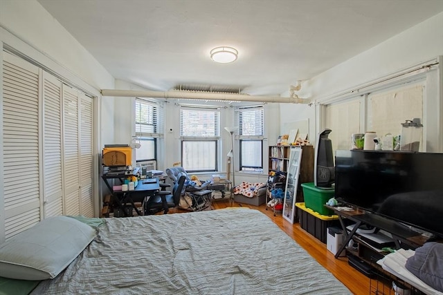 bedroom featuring wood finished floors and a closet