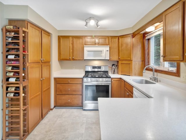 18 Sharron Dr Unit 18, Easton, MA 02375 - kitchen with white appliances, brown cabinets, light countertops, and light tile patterned floors
