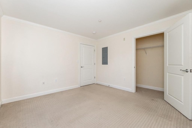8 Crowninshield Unit 312, Peabody, MA 01960 - unfurnished bedroom with electric panel, light colored carpet, crown molding, baseboards, and a closet
