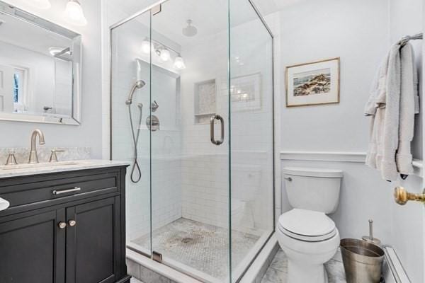 5 Hickory Rd, Southborough, MA 01772 - bathroom featuring a stall shower, vanity, toilet, marble look tiles, and a baseboard heating unit