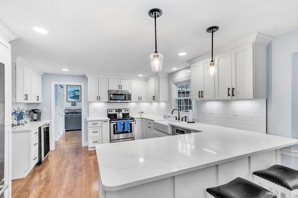 5 Hickory Rd, Southborough, MA 01772 - kitchen with appliances with stainless steel finishes, beverage cooler, a sink, a peninsula, and backsplash